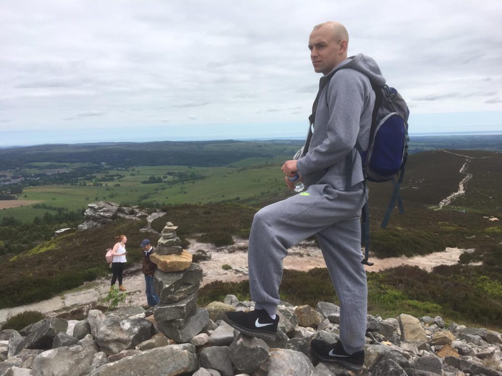 Milo standing on top of a hill during a wellbeing event. 