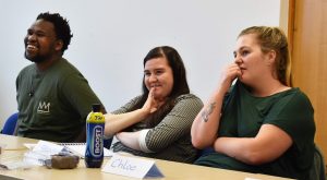 Three young people in a classroom setting, completing job training for roles in the Care industry.
