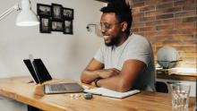 Young man on a video call, sitting at a breakfast bar in the kitchen