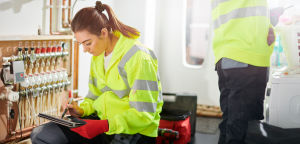 Young female Warmstart heating engineer at work in a customer's home.